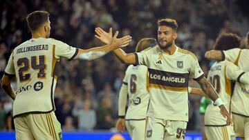 Sep 18, 2024; Los Angeles, California, USA; LAFC forward Denis Bouanga (99) and defender Ryan Hollingshead (24) celebrate after a goal by forward David Martinez (30) in the second half against Austin FC at BMO Stadium. Mandatory Credit: Jayne Kamin-Oncea-Imagn Images