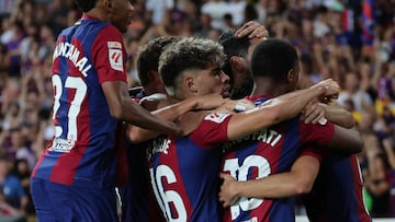 Barcelona's players celebrate their team's first goal during the Spanish Liga football match between FC Barcelona and Cadiz CF at the Lluis Companys Olimpic Stadium in Barcelona on August 20, 2023. (Photo by LLUIS GENE / AFP)