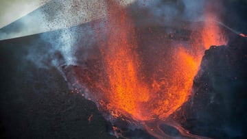 In this handout photograph taken and released by the Spanish Military Emergency Unit (UME) on November 28, 2021 the Cumbre Vieja volcano spews lava, ash and smoke on the Canary island of La Palma. 