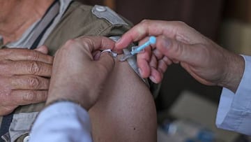 A Palestinian Muslim pilgrim gets a dose of the Pfizer-BioNTech vaccine against COVID-19 at the Rafah border crossing with Egypt on June 21, 2022, as they head to Saudi Arabia for the annual Hajj pilgrimage. - The Hajj, largest annual pilgrimage in the world, is the fifth pillar of Islam, a religious duty that must be carried out at least once in the lifetime of every able-bodied Muslim who can afford to do so. (Photo by SAID KHATIB / AFP) (Photo by SAID KHATIB/AFP via Getty Images)