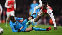 Danny Welbeck of Arsenal is fouled by Gerard Pique of Barcelona during the UEFA Champions League round of 16, first leg match between Arsenal FC and FC Barcelona at the Emirates Stadium.