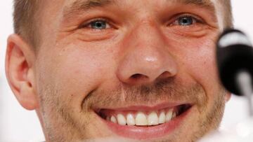 Lukas Podolski smles as he receives applause for an answer during a press conference at the base camp of the German national soccer team in Evian-Les-Bains, France, Tuesday, June 14, 2016.