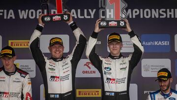 First placed Kalle Rovanpera of Finland and his co-driver Jonne Halttunen of Finland celebrate during the podium ceremony of the Orlen 80th Rally Poland in Mikolajki, on June 30, 2024. (Photo by Wojtek Radwanski / AFP)