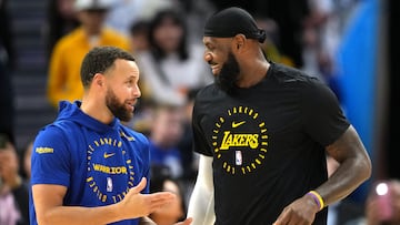 Dec 25, 2024; San Francisco, California, USA; Golden State Warriors guard Stephen Curry (left) and Los Angeles Lakers forward LeBron James (right) talk before the game at Chase Center. Mandatory Credit: Darren Yamashita-Imagn Images