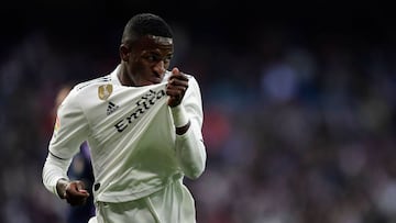 Real Madrid&#039;s Brazilian forward Vinicius Junior kisses his jersey after scoring a goal during the Spanish league football match between Real Madrid CF and Real Valladolid FC at the Santiago Bernabeu stadium in Madrid on November 3, 2018. (Photo by JA