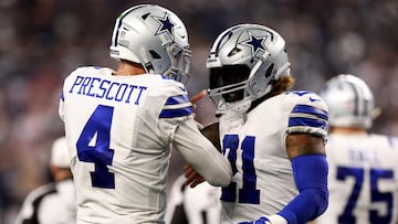 ARLINGTON, TEXAS - DECEMBER 11: Dak Prescott #4 of the Dallas Cowboys and Ezekiel Elliott #21 of the Dallas Cowboys celebrate in the fourth quarter of a game against the Houston Texans at AT&T Stadium on December 11, 2022 in Arlington, Texas.   Tom Pennington/Getty Images/AFP (Photo by TOM PENNINGTON / GETTY IMAGES NORTH AMERICA / Getty Images via AFP)