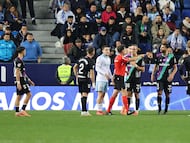 Los jugadores del Málaga CF rodean al árbitro tras el penalti pitado a Recio.