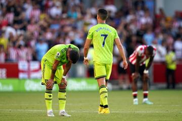 Manchester United's Bruno Fernandes, (left) is dejected at the final whistle as team mate Cristiano Ronaldo walks off 
