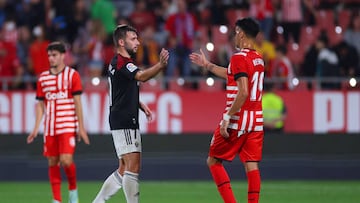 GIRONA, SPAIN - OCTOBER 23: Jon Moncayola of Osasuna embraces Reinier of Girona FC after the LaLiga Santander match between Girona FC and CA Osasuna at Montilivi Stadium on October 23, 2022 in Girona, Spain. (Photo by Eric Alonso/Getty Images)