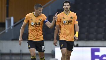 Wolverhampton Wanderers' Raul Jimenez, right, talks with his captain Conor Coady after scoring his team's first goal from the penalty spot during the Europa League round of 16 second leg soccer match between Wolves and Olympiakos at Molineux Sta