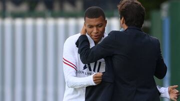 Paris Saint-Germain's Brazilian sporting director Leonardo embraces Paris Saint-Germain's French forward Kylian Mbappe prior to a training session at the Camp des Loges Paris Saint-Germain football club's training ground in Saint-Germain-en
