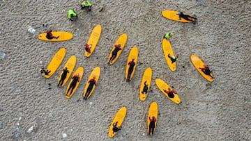 This aerial view image shows surfers from a local Surf Camp with their instructors as they warm up ahead of a surfing session on September 30, 2020 in Klitmoller, Denmark. - On Denmark's rugged western coast, far from paradise islands in the tropics,