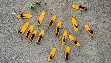 This aerial view image shows surfers from a local Surf Camp with their instructors as they warm up ahead of a surfing session on September 30, 2020 in Klitmoller, Denmark. - On Denmark&#039;s rugged western coast, far from paradise islands in the tropics,