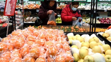 People shop for fruit at a market in Beijing on February 16, 2022.