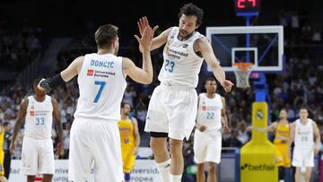 Luka Doncic y Sergio Llull se saludan tras una buena acci&oacute;n del Real Madrid.