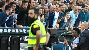 Supporters react as Real Madrid's Brazilian forward Vinicius Junior leaves after being sent off the pitch by the referee during the Spanish league football match between Valencia CF and Real Madrid CF at the Mestalla stadium in Valencia on May 21, 2023. Spanish prosecutors opened a probe on May 22, 2023 into racist chants aimed at Real Madrid's star forward Vinicius Junior during a match as the football federation president admitted the country had a "problem" with racism. (Photo by JOSE JORDAN / AFP)