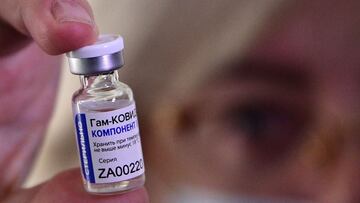 (FILES) In this file photo taken on December 14, 2020, a medical worker shows a vial with Sputnik V (Gam-COVID-Vac) vaccine against the coronavirus disease during the vaccination of medics at a clinic in the far eastern city of Vladivostok. - The Argentinean Health Ministry on December 23 authorized "with emergency character" the Sputnik V vaccine, whose first shipment is expected on Thursday in the South American country, after having approved the Pfizer-BioNTech vaccine, with which the government is negotiating a supply agreement. (Photo by Pavel KOROLYOV / AFP)