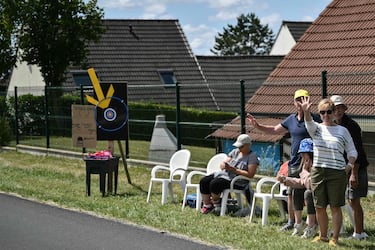 Espectadores con una red improvisada para atrapar los artículos promocionales ("goodies") distribuidos por la caravana publicitaria del Tour de Francia, así como las bidones de los ciclistas.