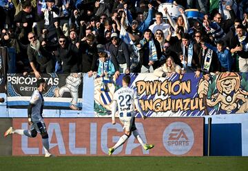 Leganes' Serbian defender #22 Matija Nastasic (R) celebrates with supporters after scoring his team's first goal during the Spanish league football match between Club Deportivo Leganes SAD and Club Atletico de Madrid at the Butarque Municipal stadium in Leganes on January 18, 2025. (Photo by JAVIER SORIANO / AFP)