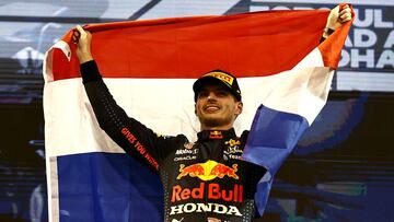 ABU DHABI, UNITED ARAB EMIRATES - DECEMBER 12: Race winner and 2021 F1 World Drivers Champion Max Verstappen of Netherlands and Red Bull Racing celebrates on the podium during the F1 Grand Prix of Abu Dhabi at Yas Marina Circuit on December 12, 2021 in Ab