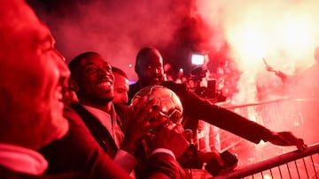Paris Saint-Germain's French forward Ousmane Dembele celebrates with supporters after receiving the Ballon d'Or award at the end of the 2025 Ballon d'Or France Football award ceremony outside the Theatre du Chatelet in Paris on September 22, 2025. (Photo by FRANCK FIFE / AFP)
