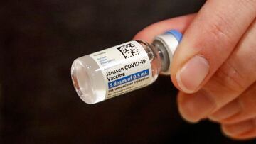 (FILES) In this file photo taken on March 5, 2021 registered nurse Florisa N. Lingad holds a Johnson &amp; Johnson Janssen Covid-19 vaccine at a vaccination center established at the Hilton Chicago O&#039;Hare Airport Hotel in Chicago, Illinois. - Top US 