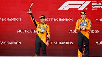 Second placed McLaren's British driver Lando Norris lifts his trophy as winner McLaren's Australian driver Oscar Piastri looks on after the Formula One Belgian Grand Prix at the Spa-Francorchamps circuit in Spa, on July 27, 2025. (Photo by SIMON WOHLFAHRT / AFP)