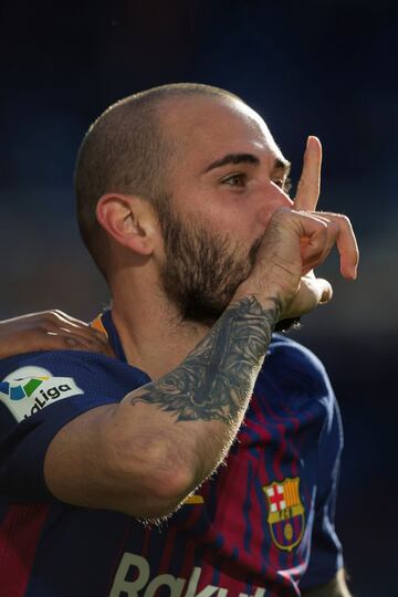 Aleix Vidal celebrates with teammates Lionel Messi and Andre Gomes after scoring his side's third goal.