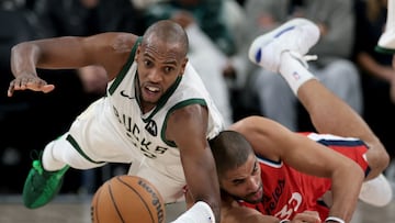 Khris Middleton #22 of the Milwaukee Bucks dives for a loose ball with Nicolas Batum #33 of the LA Clippers during the first half at Intuit Dome on January 25, 2025 in Inglewood, California.