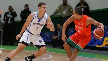 Nicaragua's Farell Pauth and Mexico's Paul Stoll fight for the ball during the FIBA AmeriCup 2025 qualifiers group C basketball match between Mexico and Nicaragua at the Miguel Barragan Auditorium in San Luis Potosi, Mexico, on February 21, 2025. (Photo by Mario ARMAS / AFP)