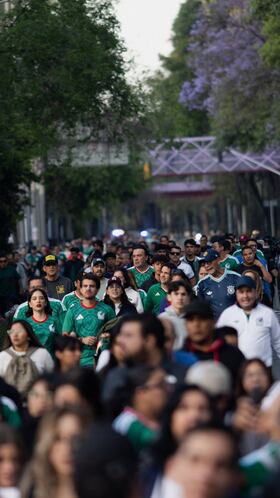 Fans walk near Azteca Stadium, officially renamed Estadio Banorte, on the day of a friendly match between the national teams of Mexico and Portugal held to mark the stadium's inauguration, as Mexico prepares for the 2026 FIFA World Cup co-hosted by the United States, Canada and Mexico, in Mexico City, Mexico, March 28, 2026. REUTERS/Quetzalli Nicte-Ha