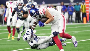 Nov 28, 2024; Arlington, Texas, USA; New York Giants tight end Theo Johnson (84) makes a catch as Dallas Cowboys linebacker DeMarvion Overshown (13) defends during the first half at AT&T Stadium. Mandatory Credit: Chris Jones-Imagn Images