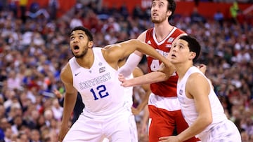 Karl-Anthony Towns #12 and Devin Booker #1 of the Kentucky Wildcats battle for position on a free throw with Frank Kaminsky #44 of the Wisconsin Badgers in the first half during the NCAA Men's Final Four Semifinal at Lucas Oil Stadium on April 4, 2015 in Indianapolis, Indiana.