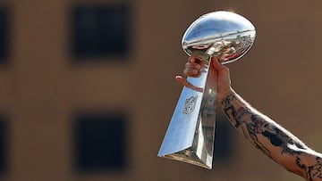 TAMPA, FLORIDA - FEBRUARY 10: Mike Evans #13 of the Tampa Bay Buccaneers celebrates their Super Bowl LV victory with the Vince Lombardi trophy during a boat parade through the city on February 10, 2021 in Tampa, Florida.   Mike Ehrmann/Getty Images/AFP
 =