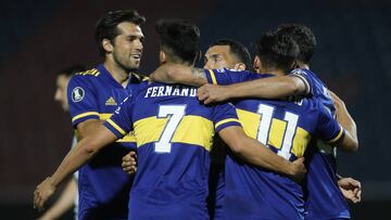 Argentina's Boca Juniors midfielder Eduardo Salvio celebrates with teammates after scoring against Paraguay's Libertad during their closed-door Copa Libertadores group phase football match at the La Nueva Olla stadium in Asuncion, on September 17, 2020, amid the COVID-19 novel coronavirus pandemic. (Photo by Jorge SAENZ / various sources / AFP)