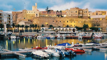 Sunset view of Sailing boats moored at the harbor of Melilla with the Old city Fortress at the back.