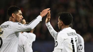 Real Madrid's Brazilian forward #11 Rodrygo (C) celebrates with Real Madrid's English midfielder #05 Jude Bellingham (L) after scoring his second goal during the UEFA Champions League, league phase - matchday 8 between Stade Brestois 29 (Brest) and Real Madrid CF at the Roudourou Stadium in Guingamp, north-western France, on January 29, 2025. (Photo by Damien MEYER / AFP)