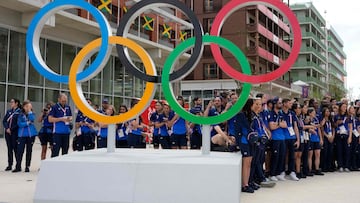 French athletes gather behind the Olympic Rings at the Olympic Village, in Saint-Denis, northern Paris, on July 22, 2024, ahead of the opening ceremony of Paris 2024 Olympic and Paralympic Games. (Photo by Michel Euler / POOL / AFP)