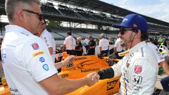 May 20, 2017; Indianapolis, IN, USA; Gil de Ferran, left, shakes hands with Fernando Alonso as he waits in line during qualifying for the 101st Running of the Indianapolis 500 at Indianapolis Motor Speedway. Mandatory Credit: Thomas J. Russo-USA TODAY Sports