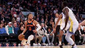 Feb 29, 2024; New York, New York, USA; New York Knicks guard Jalen Brunson (11) controls the ball against Golden State Warriors forward Jonathan Kuminga (00) and forward Draymond Green (23) during the first quarter at Madison Square Garden. Mandatory Credit: Brad Penner-USA TODAY Sports