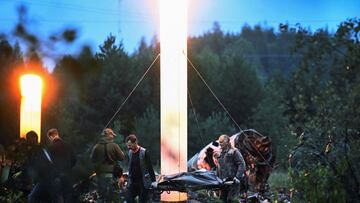 Emergency specialists carry a body bag near wreckages of the private jet linked to Wagner mercenary chief Yevgeny Prigozhin at the crash site in the Tver region, Russia, August 24, 2023. Kommersant Photo/Dmitry Lebedev via REUTERS RUSSIA OUT. NO COMMERCIAL OR EDITORIAL SALES IN RUSSIA.