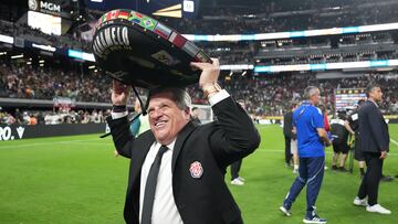 Jun 22, 2025; Las Vegas, Nevada, USA; Costa Rica head coach Miguel Herrera tries on a hat while walking off the pitch following a draw to Mexico during a group stage match of the 2025 Gold Cup at Allegiant Stadium. Mandatory Credit: Kirby Lee-Imagn Images