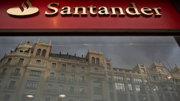 MADRID, SPAIN - JANUARY 29: A Banco Santander's logo stands on a bank's office as a building is reflected on its window a day before a news conference to announce the 2018 results on January 29, 2019 in Madrid, Spain. Banco Santander earned 7,810 million euros in 2018, an 18% increase on the previous year. (Photo by Pablo Blazquez Dominguez/Getty Images)