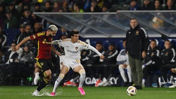 Mar 30, 2024; Carson, California, USA; LA Galaxy midfielder Riqui Puig (10) and Seattle Sounders FC defender Alex Roldan (16) chase the ball during the first half at Dignity Health Sports Park. Mandatory Credit: Jonathan Hui-USA TODAY Sports