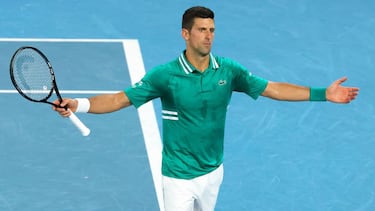 Serbia's Novak Djokovic reacts as he plays against Germany's Alexander Zverev during their men's singles quarter-final match on day nine of the Australian Open tennis tournament in Melbourne on February 16, 2021. (Photo by David Gray / AFP) / -- IMAGE RES