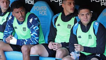 Racing Club's Colombian forward Roger Martinez (2nd L), defender Nazareno Colombo (2nd R), and Colombian midfielder Juan Fernando Quintero (R) are seen on the bench before the Argentine Professional Football League Tournament 2024 'Cesar Luis Menotti' match between Racing Club and Boca Juniors at the Presidente Peron stadium in Avellaneda, Buenos Aires province, on September 14, 2024. (Photo by ALEJANDRO PAGNI / AFP)