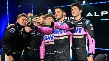 BWT Alpine F1 Team Driver Esteban Ocon (C) takes a selfie picture with BWT Alpine F1 Team Driver Pierre Gasly (rear), BWT Alpine F1 Team Reserve Driver Jack Doohan (R) and members of the BWT Alpine Endurance team including Mick Schumacher (L) during the Alpine team's 2024 season launch, in Enstone, central England, on February 7, 2024. (Photo by Ben Stansall / AFP)