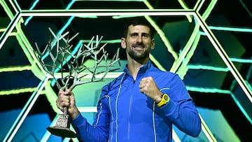 Serbia's Novak Djokovic poses with the trophy after winning the men's singles final match of the Paris ATP Masters 1000