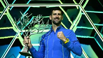 Serbia's Novak Djokovic poses with the trophy after winning the men's singles final match of the Paris ATP Masters 1000