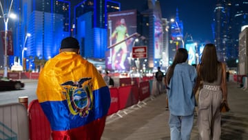 DOHA, QATAR - November 19: A fan of Ecuador with his national flag whilst in West Bay, Doha ahead of the FIFA World Cup Qatar 2022 at  on November 19, 2022 in Doha, Qatar. (Photo by Matthew Ashton - AMA/Getty Images)
